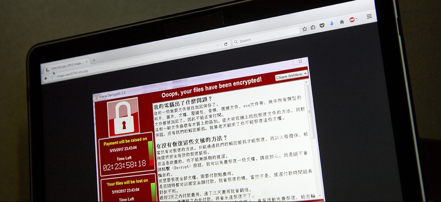 A screenshot of the warning screen from a purported ransomware attack, as captured by a computer user in Taiwan, is seen on laptop in Beijing.