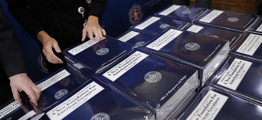 Senate Budget Committee staff members lay out copies of President Donald Trump's fiscal 2018 federal budget for distribution on Capitol Hill, May 23, 2017.