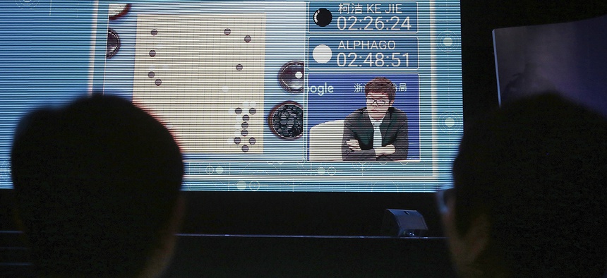 Spectators watch a video screen as Go player Ke Jie plays a match against Google's artificial intelligence program, AlphaGo, during the Future of Go Summit in Wuzhen in eastern China's Zhejiang Province, May 23, 2017.