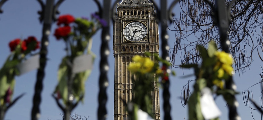 Floral tributes to the victims of the Westminster terrorist attack are placed outside the Palace of Westminster, London, Monday March 27, 2017.