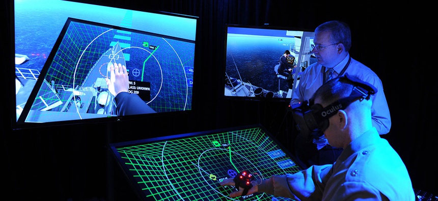 Jim Blesse, standing, from the Office of Naval Research (ONR), explains project BlueShark to Lt. Col. John Moore from the Marine Corps Warfighting Laboratory.