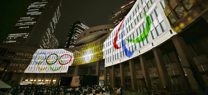 Olympic logos are projected on Tokyo Metropolitan Government building during the Tokyo 2020 flag tour festival for the 2020 Games in Tokyo, Monday, July 24, 2017.