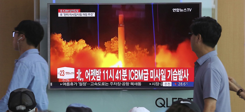 People watch a TV news program showing an image of North Korea's latest test launch of an intercontinental ballistic missile (ICBM), at the Seoul Railway Station in Seoul, South Korea, Saturday, July 29, 2017.