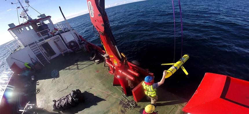 Crew members aboard the VOS Raasay recover U.S. and British Royal Navy ocean gliders taking part in the Unmanned Warrior exercise off the northwest coast of Scotland, Oct. 8, 2016.