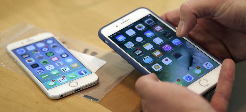 a customer setting up his new iPhone 7 Plus, right, as he switches from the iPhone 6 at the Apple Store on Michigan Avenue, Chicago, IL.