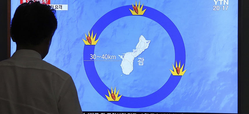 A man watches a TV screen showing a local news program reporting on North Korea's threats to strike Guam with ballistic missiles, at the Seoul Train Station in Seoul, South Korea, Thursday, Aug. 10, 2017.