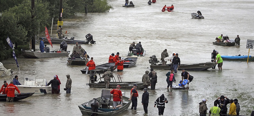 Rescue boats fill Tidwell Road as they help flood victims evacuate as floodwaters from Tropical Storm Harvey rise Monday, Aug. 28, 2017, in Houston.
