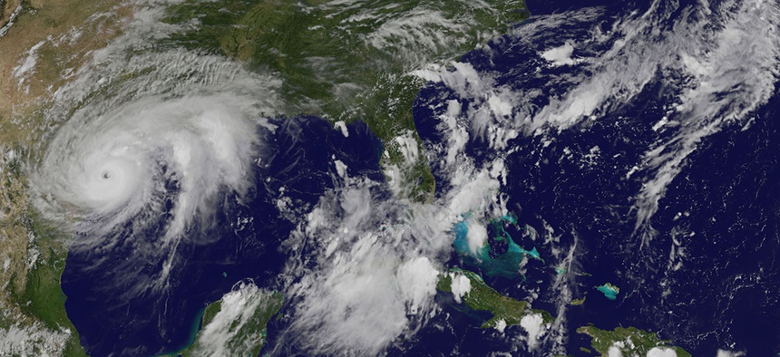 This enhanced satellite image made available by the NOAA GOES Project shows Hurricane Harvey, middle left, approaching the coast of Texas on Friday, Aug. 25, 2017.