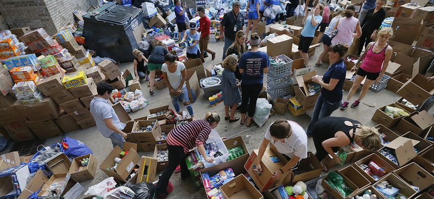 Donated items sit in a loading dock are as volunteers works to organize the items donated for Hurricane Harvey victims, Tuesday, Aug. 29, 2017, in Dallas, Texas.
