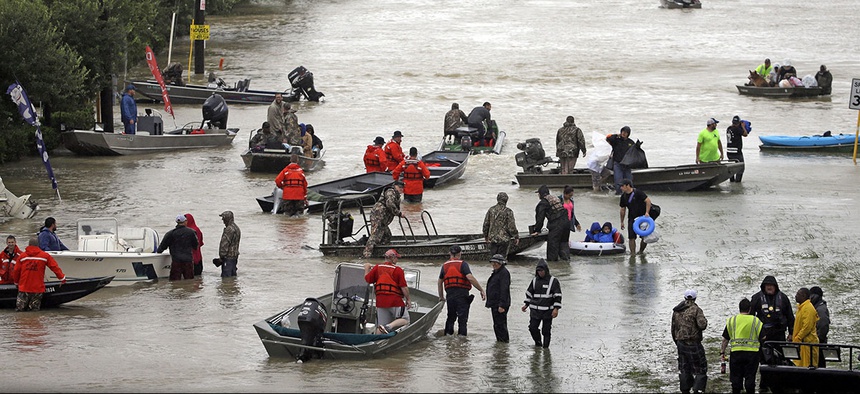 Rescue boats fill Tidwell Road as they help flood victims evacuate as floodwaters from Tropical Storm Harvey rise Monday, Aug. 28, 2017, in Houston.