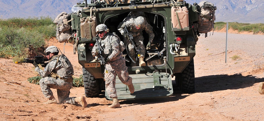 Soldiers from 1st Squadron, 1st Cavalry Regiment, 2nd Brigade, 1st Armored Division, dismount from a Stryker vehicle during the Network Integration Evaluation 13.1 at Dona Ana Range, N.M.