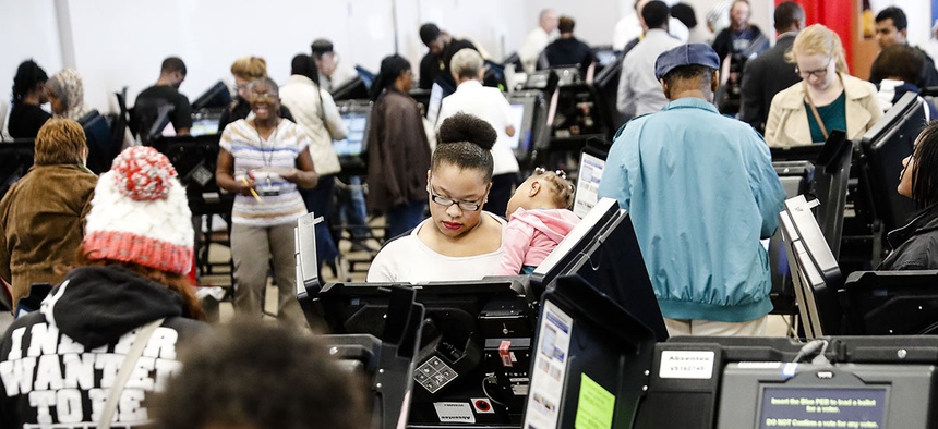 Early voters use electronic ballot casting machines at the Franklin County Board of Elections, Monday, Nov. 7, 2016, in Columbus, Ohio.