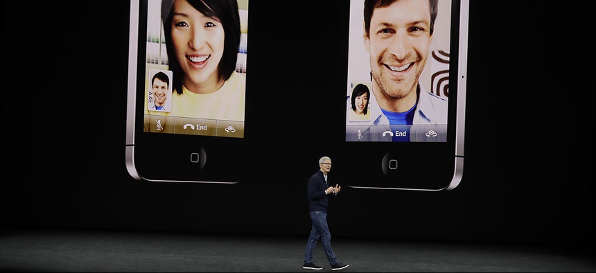 Apple CEO Tim Cook, shows the new iPhone 8 at the Steve Jobs Theater on the new Apple campus on Tuesday, Sept. 12, 2017.
