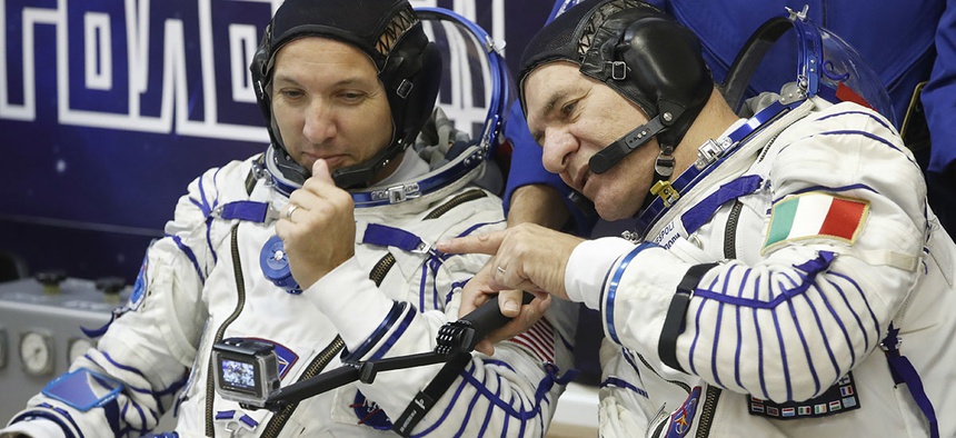 U.S. astronaut Randy Bresnik , left, and Italian astronaut Paolo Nespoli members of the main crew of the expedition to the International Space Station (ISS), look at a camera prior the launch of Soyuz MS-05 space ship.