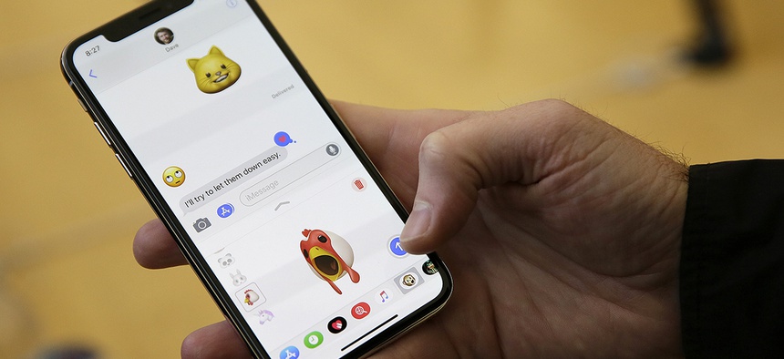 An Apple employee demonstrates the animoji feature of the new iPhone X at the Apple Union Square store Friday, Nov. 3, 2017, in San Francisco.