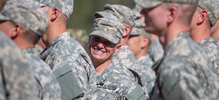 Maj. Lisa Jaster, center, stands in formation with other Rangers during an Army Ranger school graduation ceremony, Friday, Oct. 16, 2015, in Fort Benning, Ga. Jaster, who is the first Army Reserve female to graduate the Army's Ranger School.