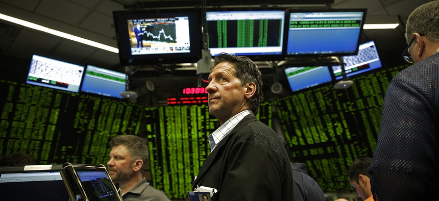 Traders work in a trading pit at the Chicago Board Options Exchange, Monday, Dec. 11, 2017, in Chicago, as they trade S&P 500 Options, unrelated to bitcoin futures. Trading in Bitcoin futures began Sunday on the CBOE.