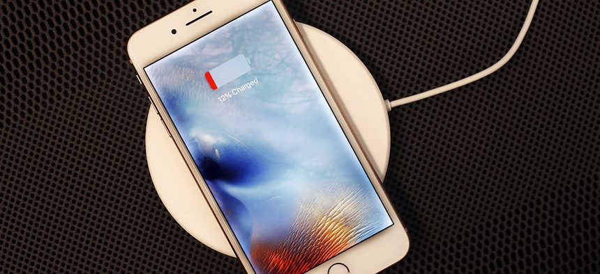 In this Sept. 15, 2017, photo, the iPhone 8 Plus rests on a wireless charger.