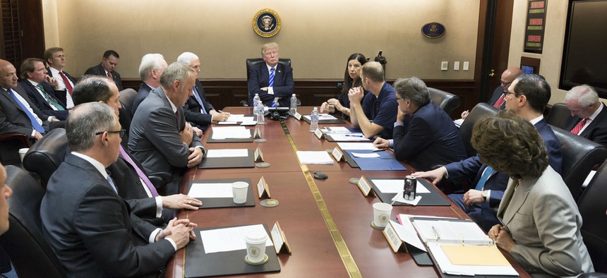 President Donald Trump, center, meets with members of his cabinet Sept. 26 in the Situation Room at the White House in Washington, as he receives the latest update on Hurricane Maria relief and recovery efforts.