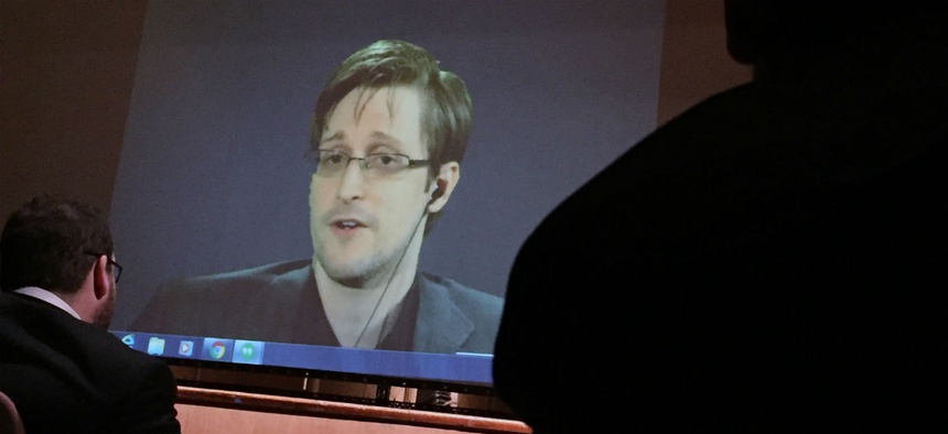 Edward Snowden speaks via video conference to people in the Johns Hopkins University auditorium February 2016.