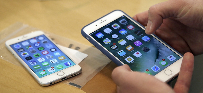 A customer sets up his new iPhone 7 Plus, right, as he switches from the iPhone 6 at the Apple Store on Michigan Avenue.