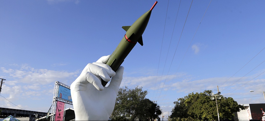 A sculpture titled "Dangerous Game" by Italian artist Lorenzo Quinn, is displayed in the Wynwood neighborhood of Miami, Friday, Dec. 8, 2017.