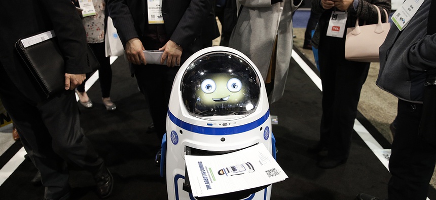 Evolver's Fabo E01 service robot carries flyers at CES International, Wednesday, Jan. 10, 2018, in Las Vegas.
