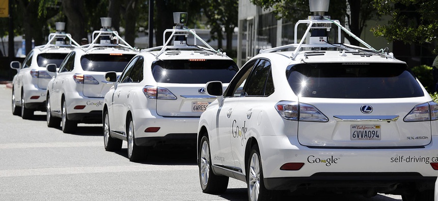 A row of Google self-driving Lexus cars at a Google event outside the Computer History Museum in Mountain View, Calif.