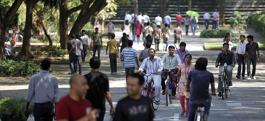 Employees of Infosys Technologies, the Indian technology outsourcing giant, move inside the company headquarters during a break after their quarterly financial results were announced in Bangalore, India.