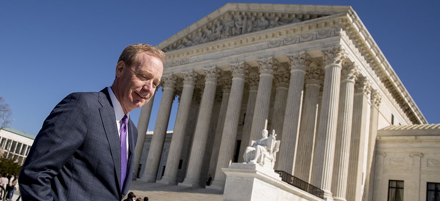 Microsoft President and Chief Legal Officer Brad Smith, left, leaves the Supreme Court, Tuesday, Feb. 27, 2018, in Washington.
