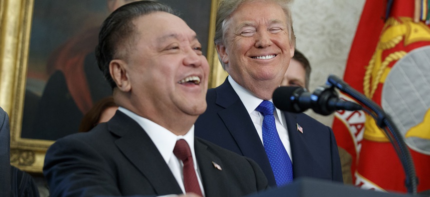 President Donald Trump smiles at Broadcom CEO Hock Tan during an event to announce that the company is moving its global headquarters to the United States, Thursday, Nov. 2, 2017.