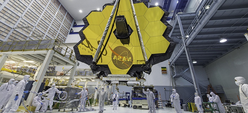 NASA technicians lift the mirror of the James Webb Space Telescope using a crane at the Goddard Space Flight Center in Greenbelt, Md.