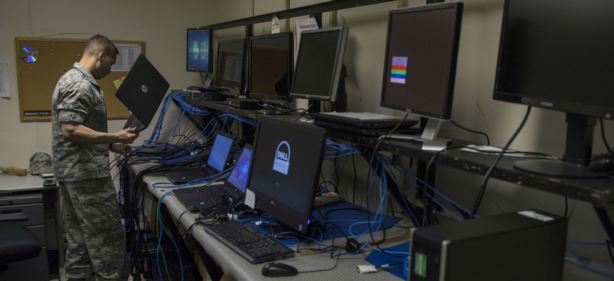 An airman prepares to image a laptop at Yokota Air Base, Japan.