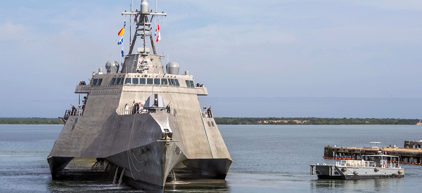 A Naval Station vessel, right, prepares to assist the future USS Omaha (LCS 12), a 218-foot-long littoral combat ship, pier side during a brief fuel stop in Guantanamo Bay, Cuba.