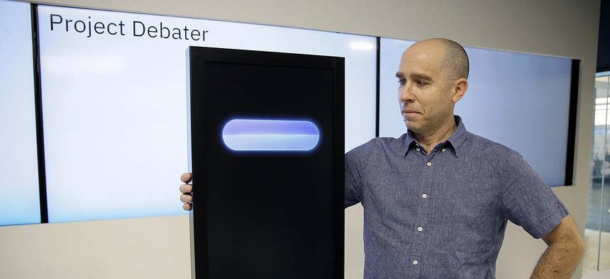 Dr. Noam Slonim, principal investigator, stands with the IBM Project Debater before a debate between the computer and two human debaters Monday, June 18, 2018, in San Francisco.