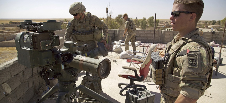 U.S. Army soldiers stands next to a a guided-missile launcher, a few miles from the frontline, in the village of Abu Ghaddur, east of Tal Afar, Iraq, Sunday, Aug. 20, 2017.
