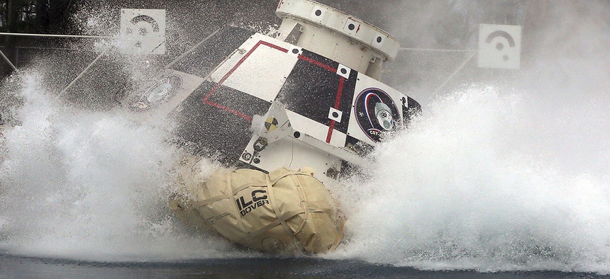 A mock-up of Boeing's CST-100 Starliner splashes down in 2016.