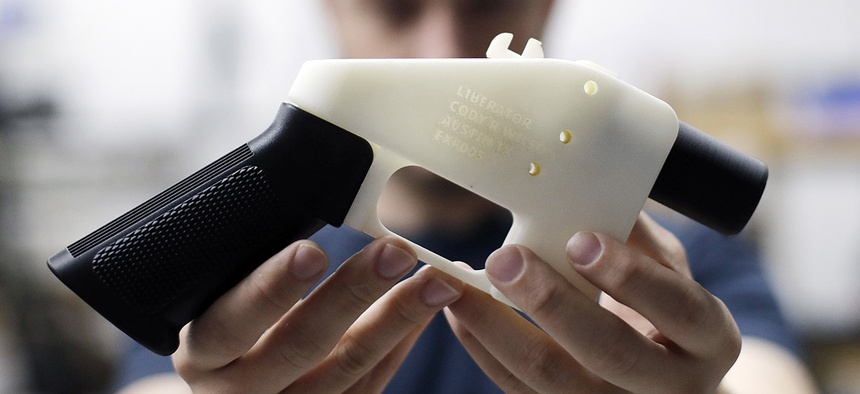 Cody Wilson, with Defense Distributed, holds a 3D-printed gun called the Liberator at his shop, Wednesday, Aug. 1, 2018, in Austin, Texas.
