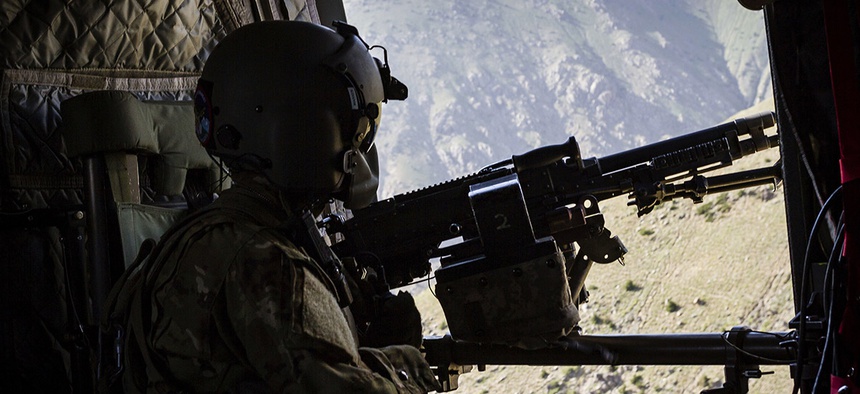 A U.S. Army CH-47 Chinook helicopter crew chief assigned to Task Force Flying Dragons, 16th Combat Aviation Brigade, 7th Infantry Division scans below near Mazar-e-Sharif, Afghanistan.