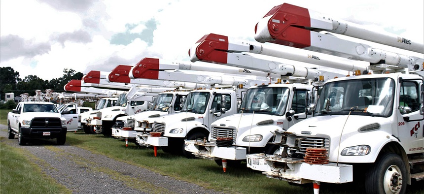 Utility trucks line up in a parking lot adjacent to Charlotte Motor Speedway in Concord, North Carolina, on Wednesday, Sept. 12, 2018.