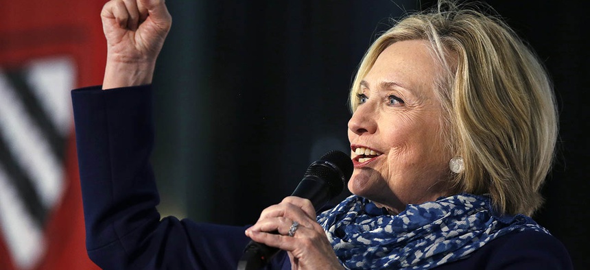 Hillary Clinton pumps her fist as she is introduced at Harvard University in Cambridge, Mass., Friday, May 25, 2018.