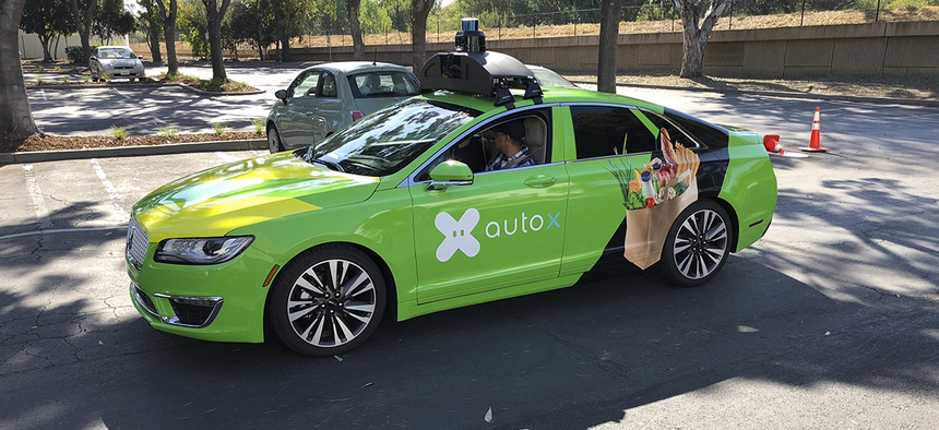 A Lincoln MKZ outfitted with AutoX's self-driving sensors sits in the parking lot of the company's headquarters in San Jose, Calif.