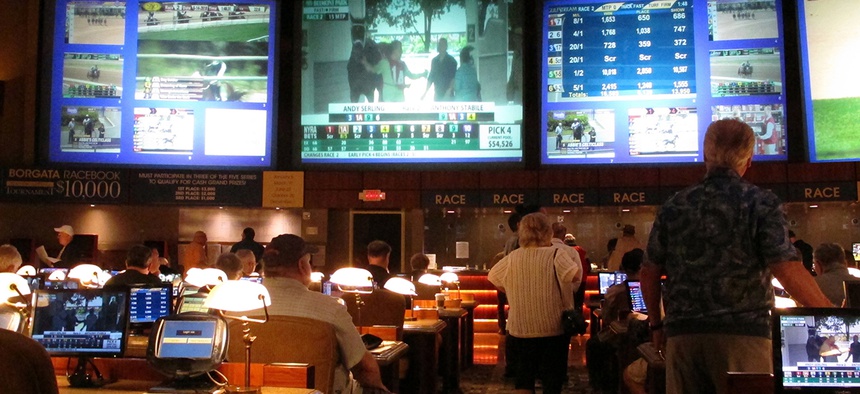 Bettors wait to make wagers on sporting events at the Borgata casino in Atlantic City, N.J.,