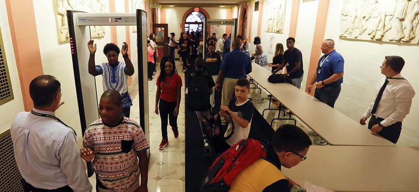 Students at William Hackett Middle School pass through metal detectors on the first day of school on Tuesday, Sept. 6, 2016, in Albany, N.Y.