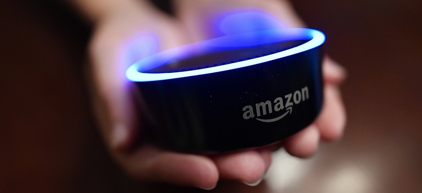 A child holds his Amazon Echo Dot in Kennesaw, Ga.