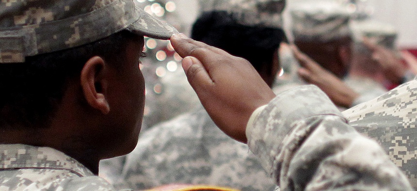 Soldiers salute the U.S. flag during the Pledge of Allegiance at a welcome home ceremony for soldiers returning from a deployment in Afghanistan, at Fort. Carson, Colo.