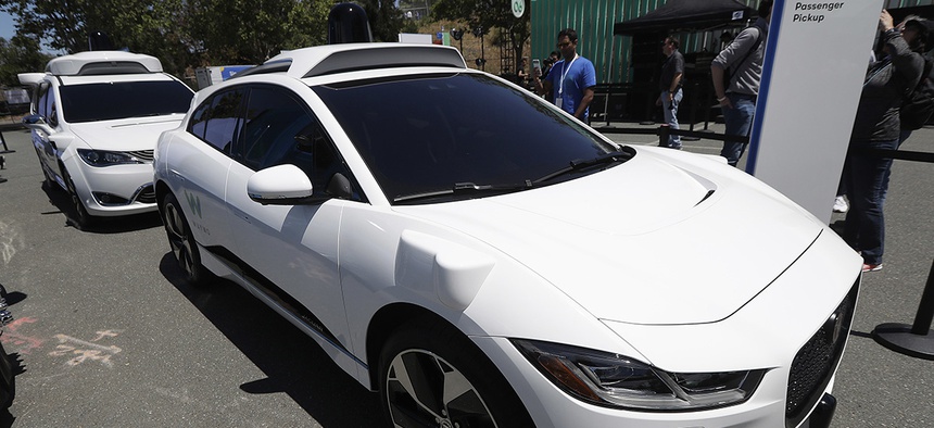 Waymo cars are displayed at the Google I/O conference in Mountain View, Calif., Tuesday, May 8, 2018.
