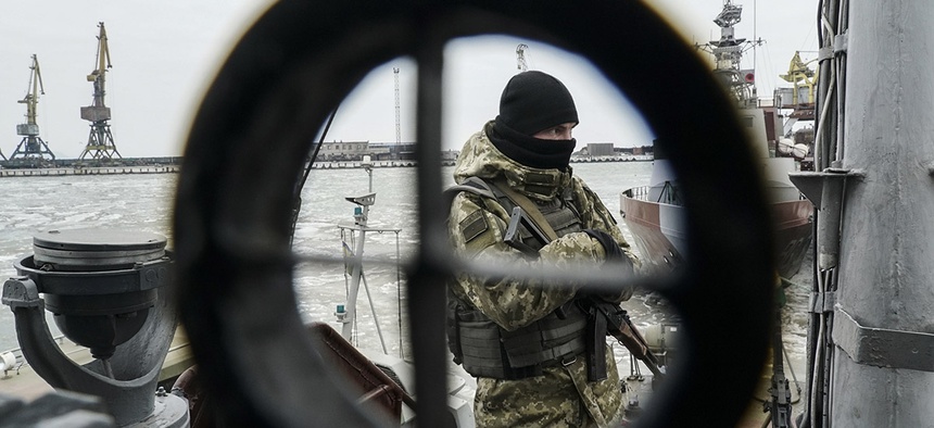 A Ukrainian serviceman stands on board a coast guard ship in the Sea of Azov port of Mariupol, eastern Ukraine, Monday, Dec. 3, 2018.
