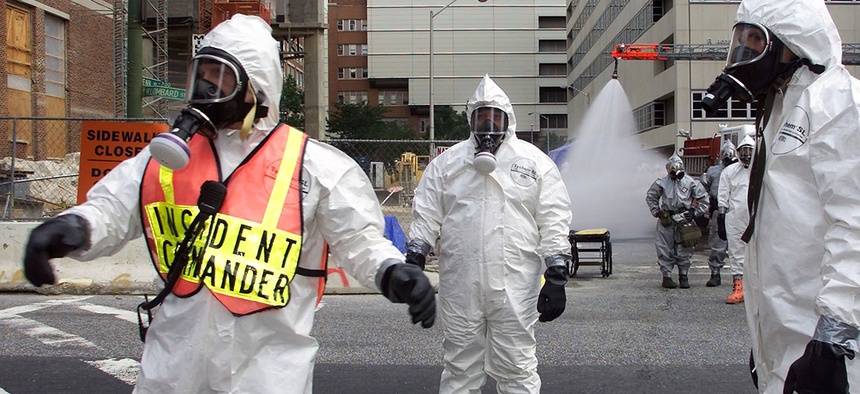 Baltimore City Fire Department Hazmat team battalion Chief Mark Wagner, left, guides operations during an emergency training exercise put on by the University of Maryland Medical Center and the U.S. Air Force to simulate a bioterror attack.