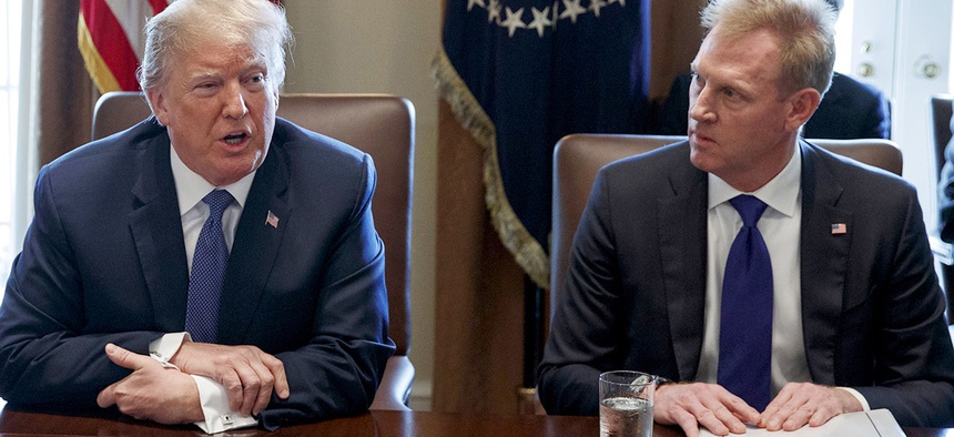 Deputy Secretary of Defense Patrick Shanahan, right, listen as President Donald Trump speaks during a cabinet meeting at the White House.